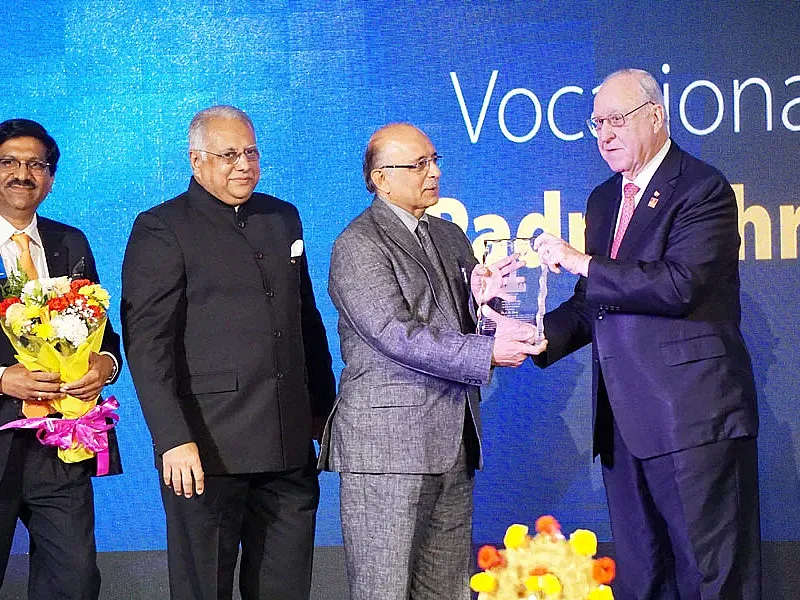 RI President John Germ honours Dr J M Hans with the Vocational Service Award in the presence of RID Manoj Desai and DG Sharat Jain.